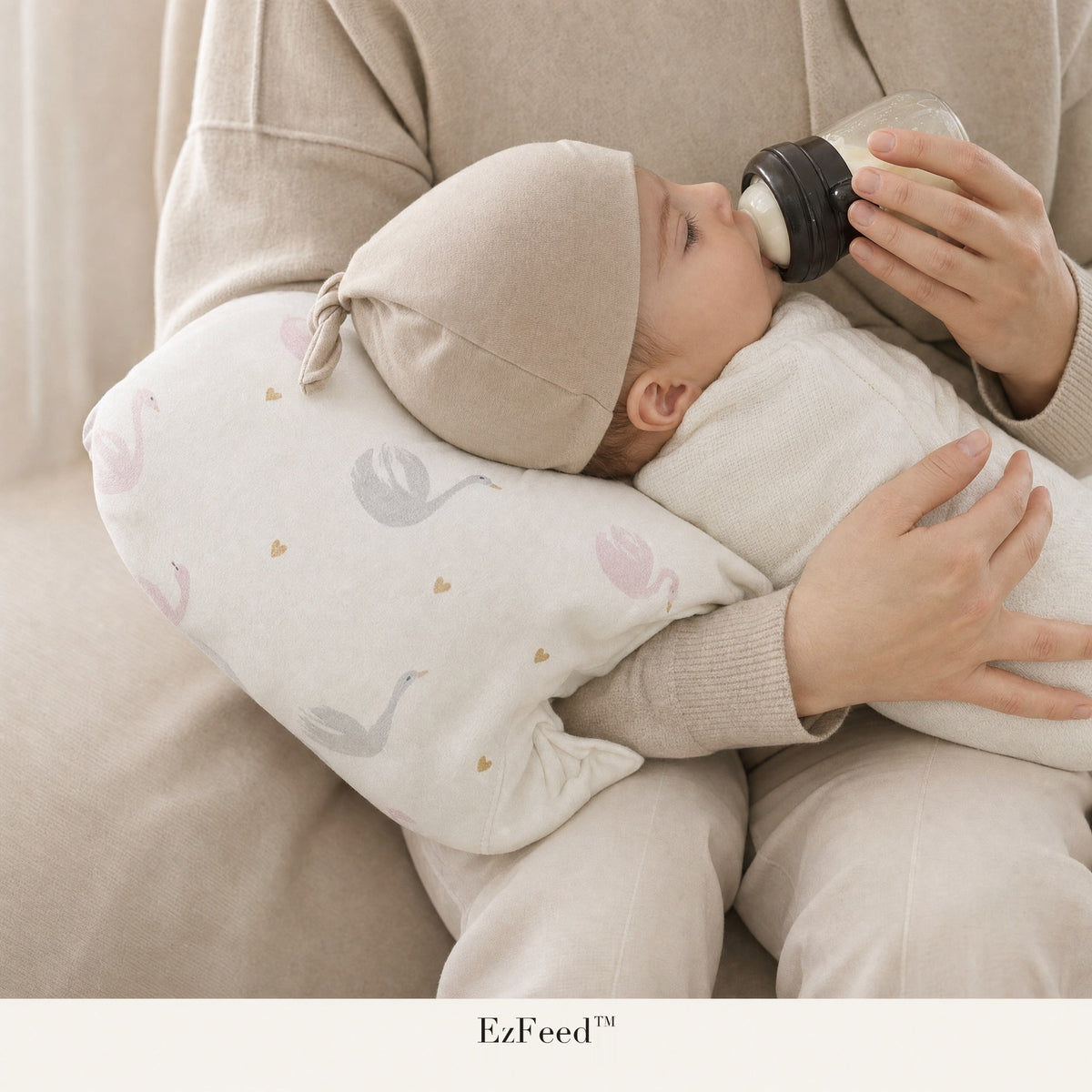 Parent feeding a baby a bottle on the EzFeed nursing arm pillow in Pearl Swan